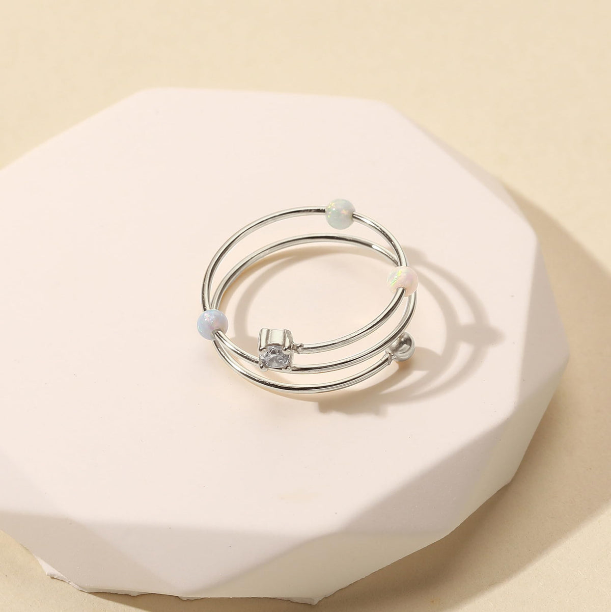 LOVECOM opal beads spinner ring detail showing three turnable opals.