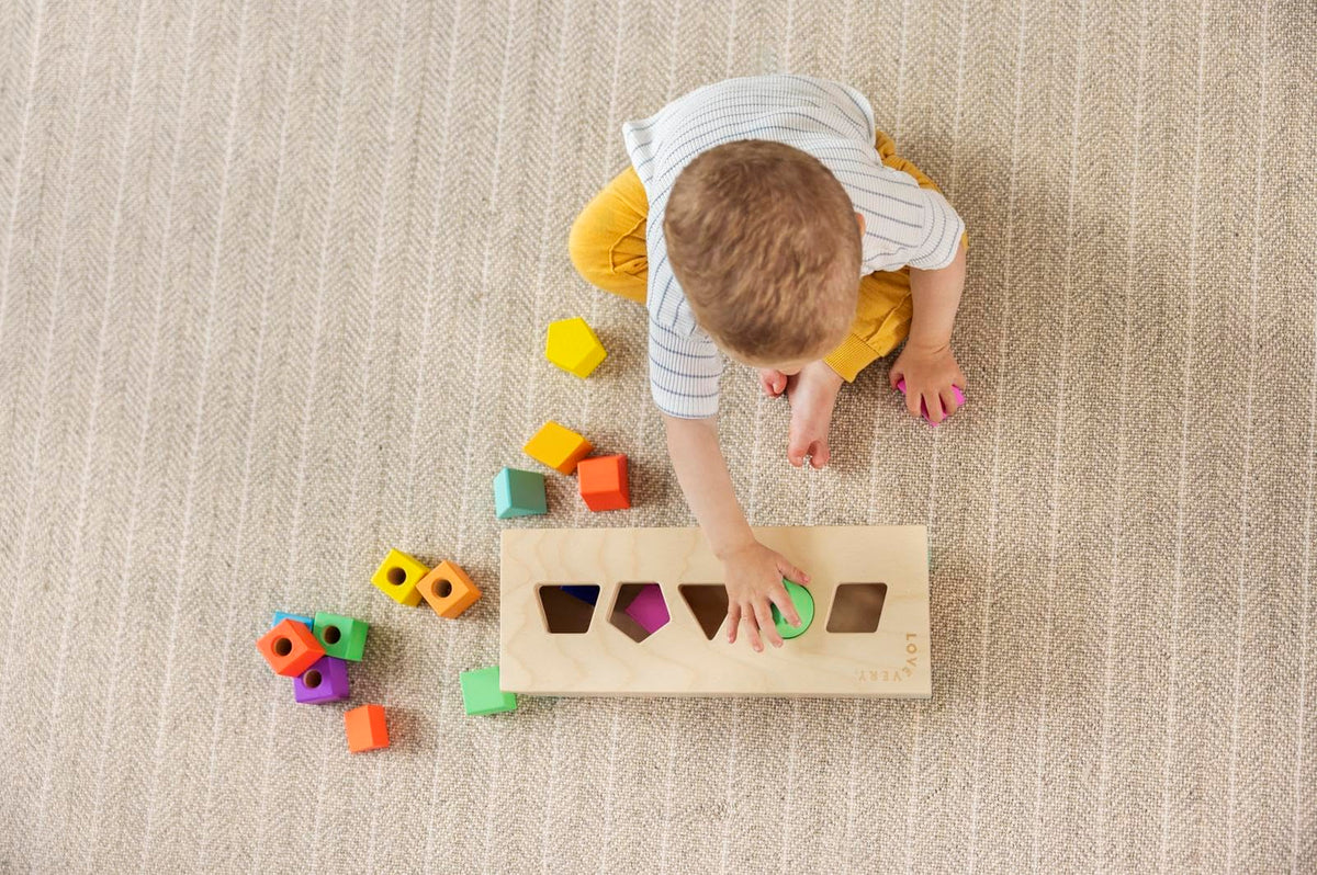 Lovevery The Block Set wooden storage box keeps pieces organized after play.
