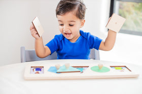 Lovevery Friends of All Shapes Puzzle: child places a piece, improving hand-eye coordination.