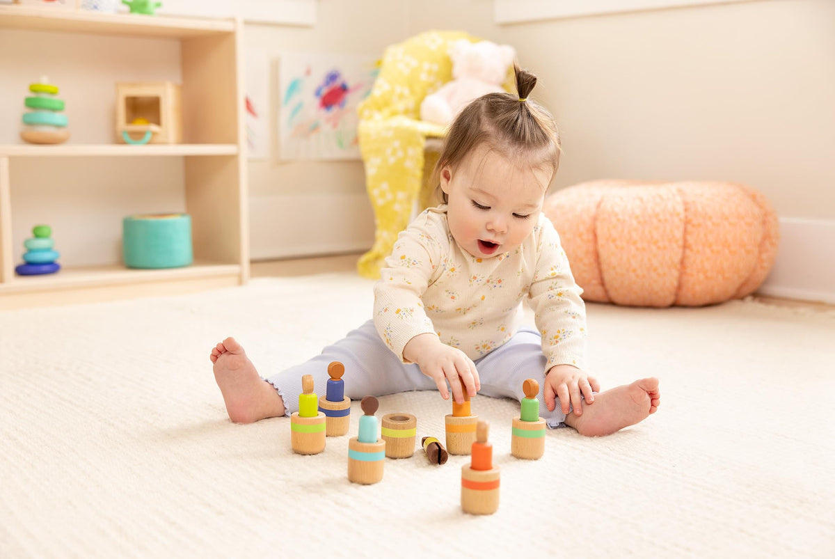 Lovevery peg dolls supporting fine motor activity with precise pinching actions.