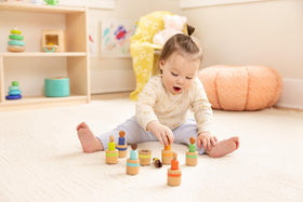 Lovevery peg dolls supporting fine motor activity with precise pinching actions.