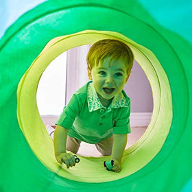 Lovevery Play Tunnel outdoors invites fresh-air exploration and family fun.