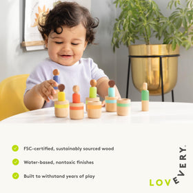 Lovevery peg dolls in a stacking sequence to enhance hand-eye coordination.