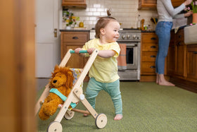 Lovevery The Buddy Stroller buckle detail, quick secure fastening for easy setup.