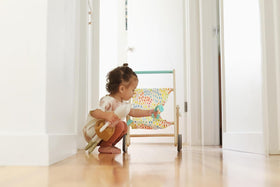 Lovevery The Buddy Stroller in use, carrying stuffed animals for open-ended play.