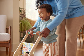 Lovevery The Buddy Stroller side view, ideal height for toddlers to push comfortably.