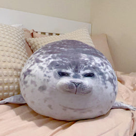 LUXSIT seal pillow on bed for large, comforting hugs.