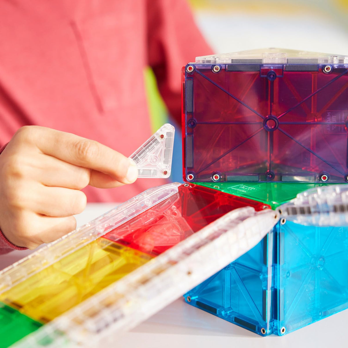 MAGNA-TILES Rail Racers ball speeds down custom tracks for kinetic learning.