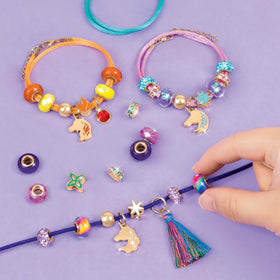 Make It Real Unicorn Academy tassel charm detail adds playful texture.