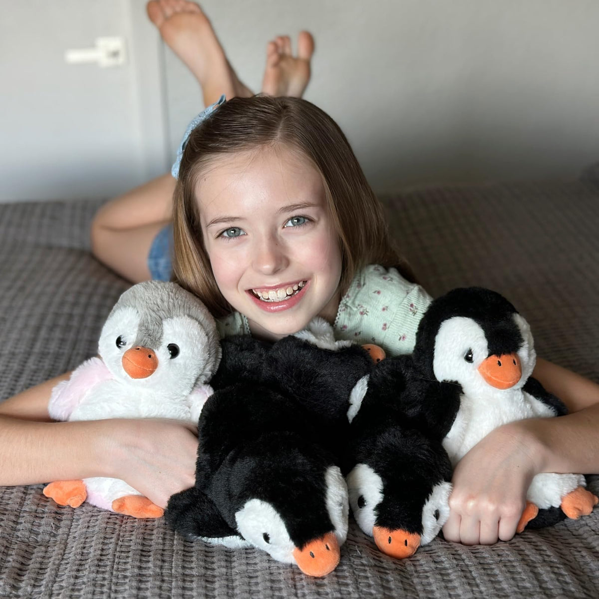 MaoGoLan penguin plush waving gesture greets guests on shelves or desks.