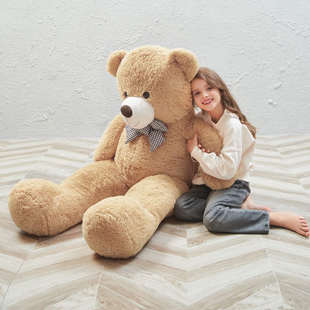 MaoGoLan giant teddy bear cuddling a child, inviting calm play and companionship.