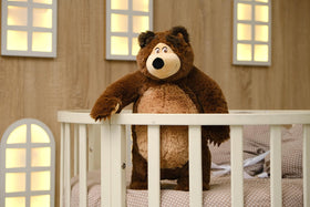 Masha and the Bear kid holding plush displays shareable comfort for kids.