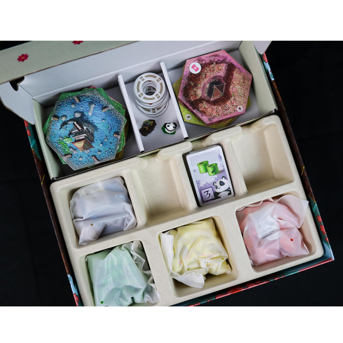 Takenoko panda miniatures and colorful plots inspire imaginative play and planning.