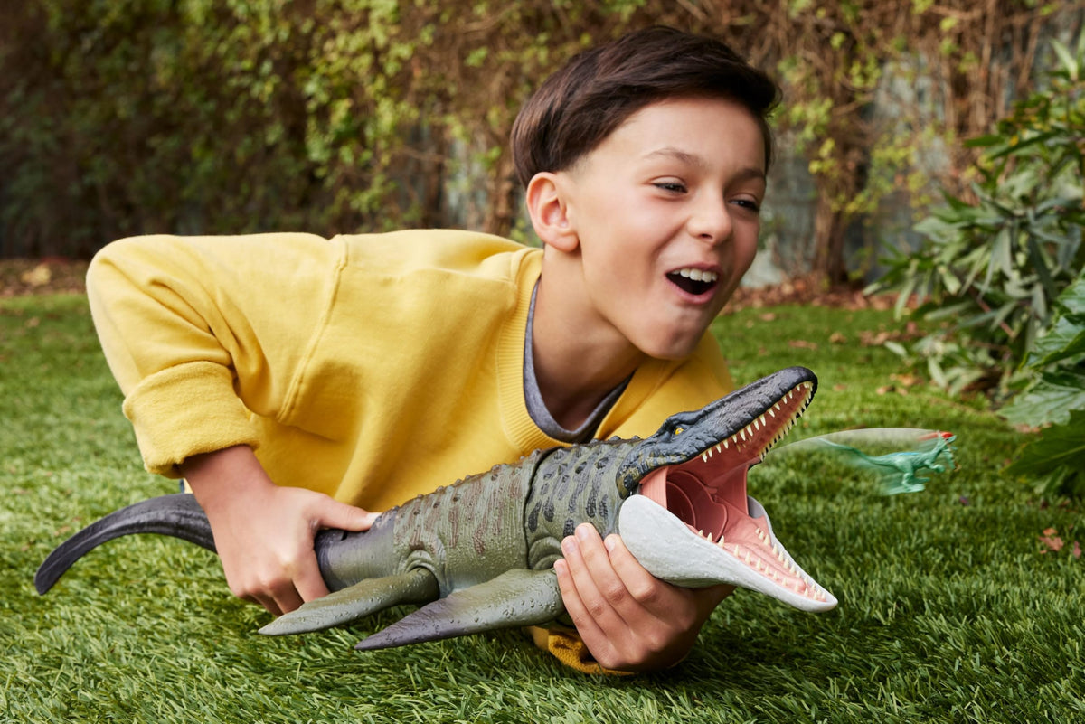 Mosasaurus swallowing the mini Dilophosaurus figure for imaginative storytelling.