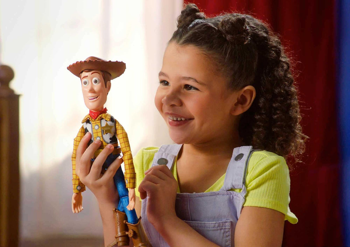 Mattel Woody soft-body figure with fabric outfit for realistic, cuddly play.
