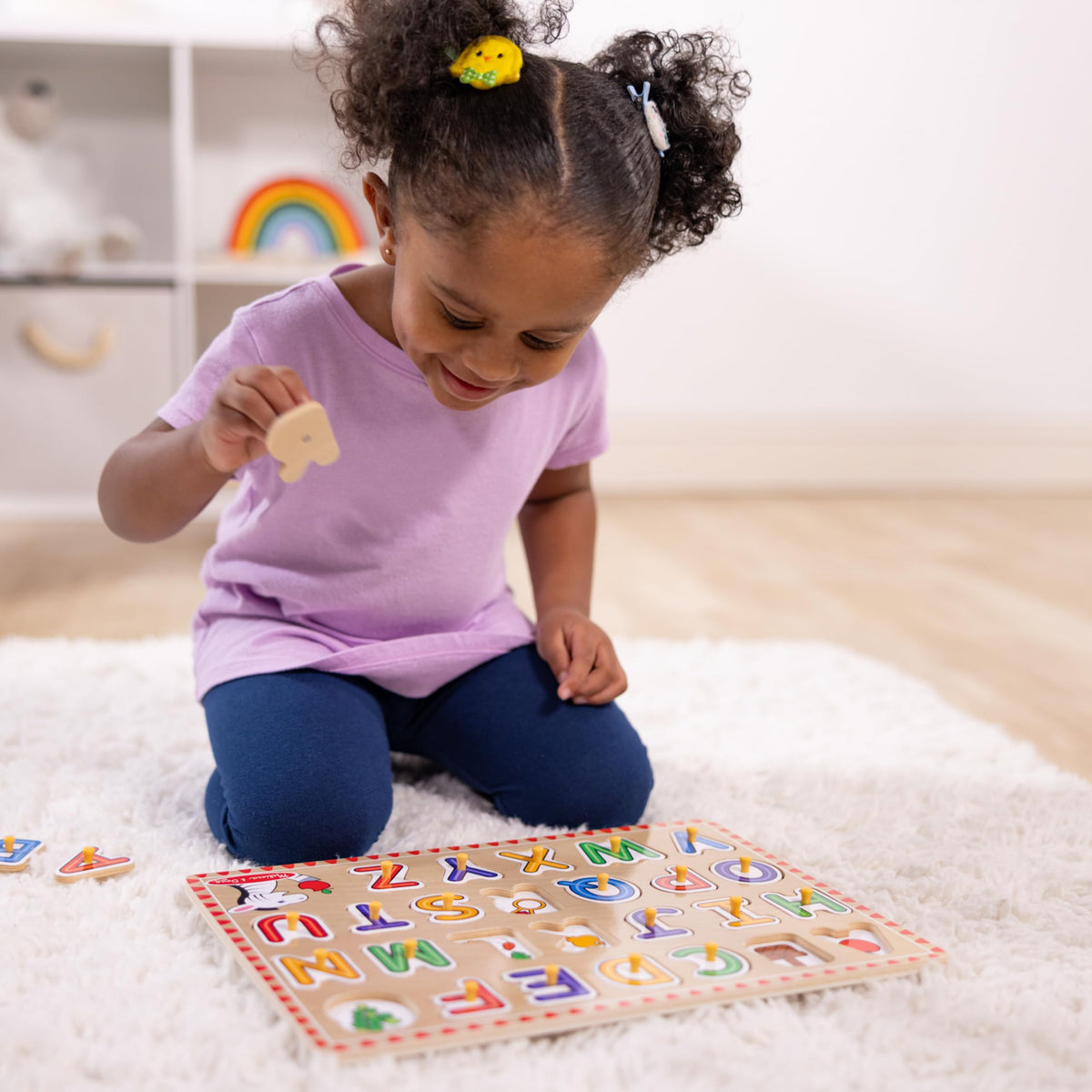 Melissa & Doug alphabet board under-piece pictures connect letters to real world objects.