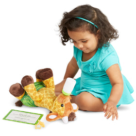Melissa and Doug baby giraffe bottle fits in the mouth for pretend feeding.