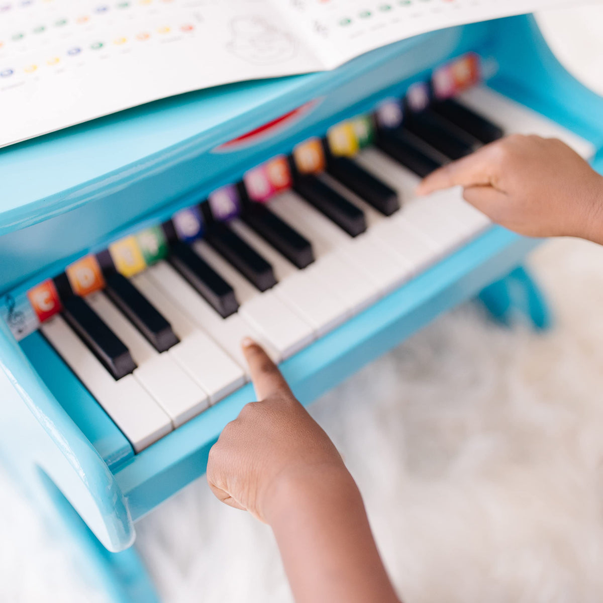 Melissa & Doug blue piano kids improving eye-hand coordination during play.