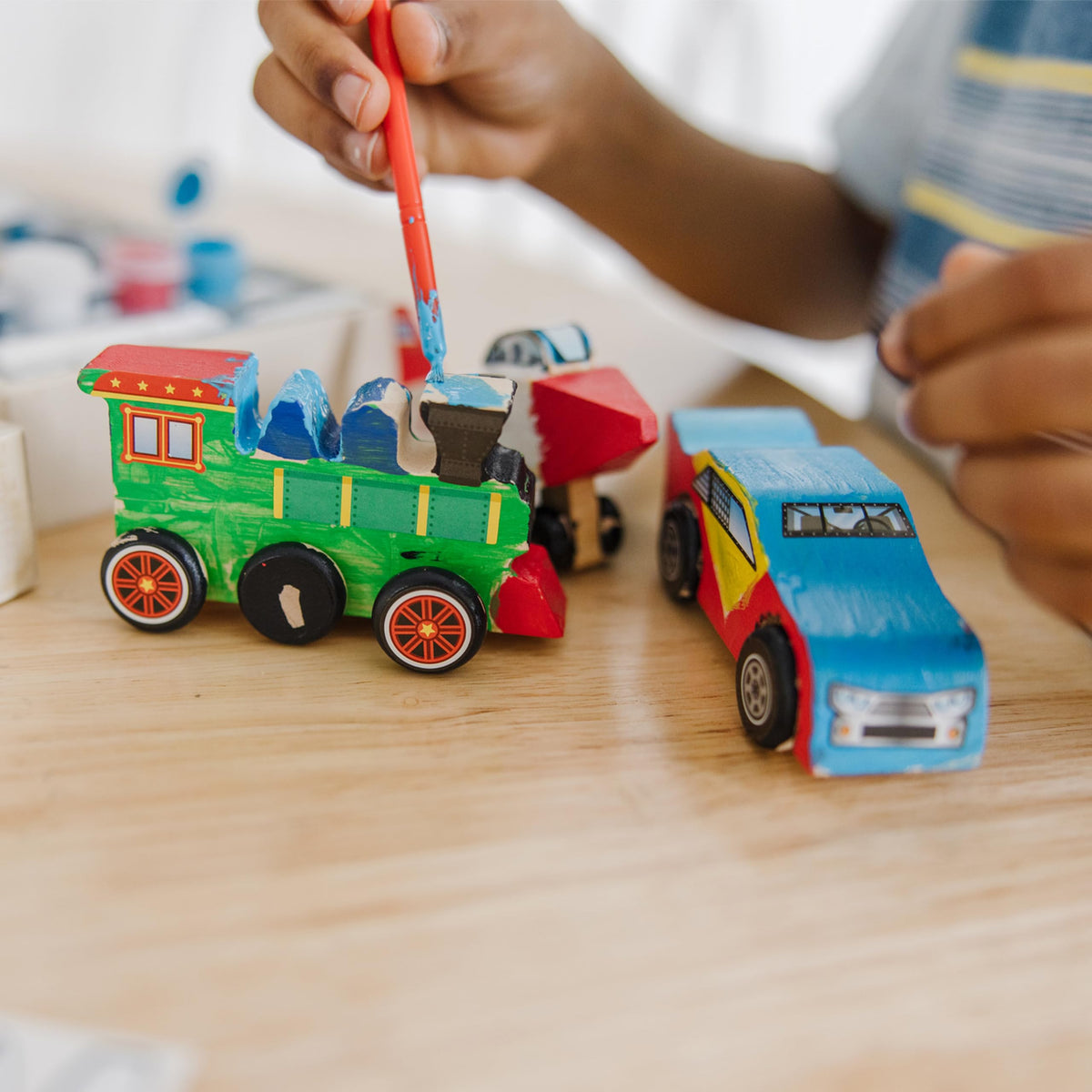 Brush and stickers set to personalize each vehicle by Melissa & Doug.