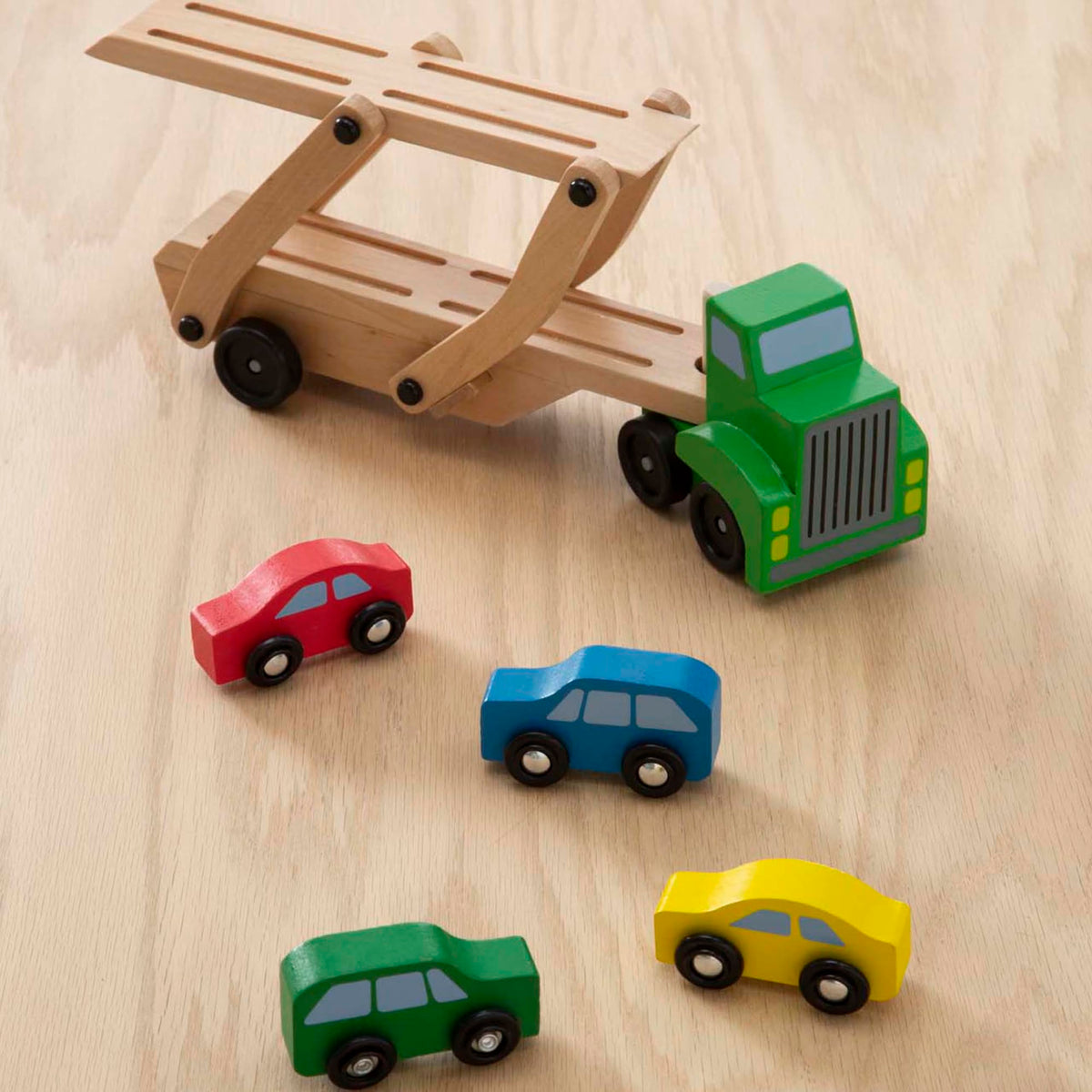 Melissa and Doug car carrier includes four cars for immediate pretend deliveries.