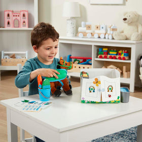 Melissa & Doug care tools such as brush and comb for grooming play.