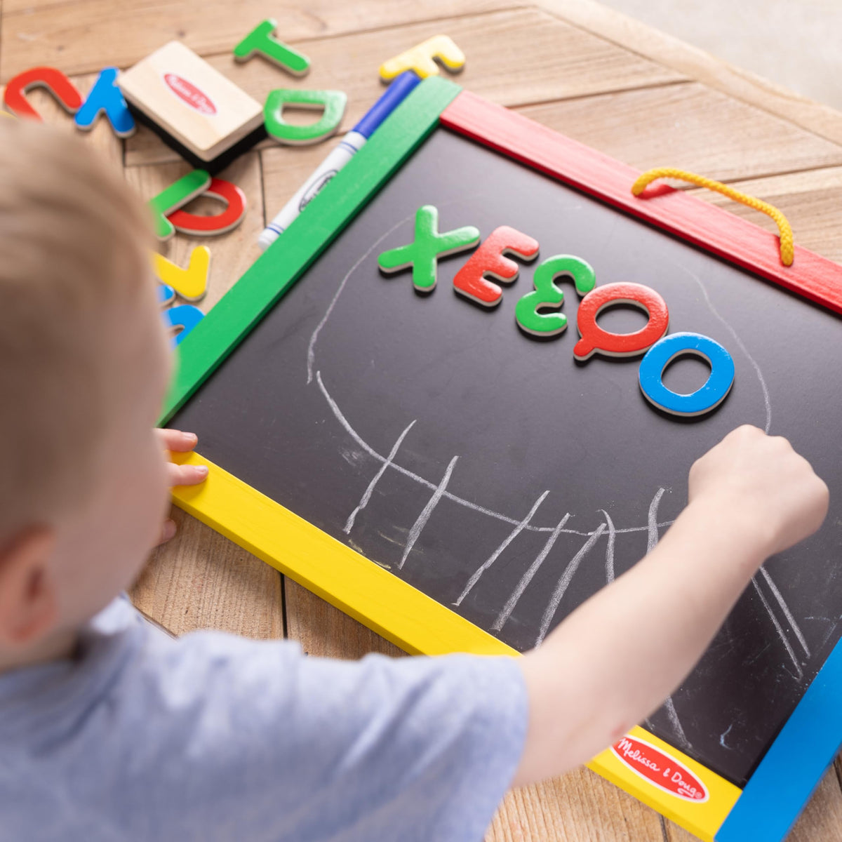 Melissa & Doug chalk and dry-erase markers included for versatile art.