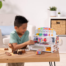 Melissa & Doug gift-box display showcases pretend candies for imaginative storefronts