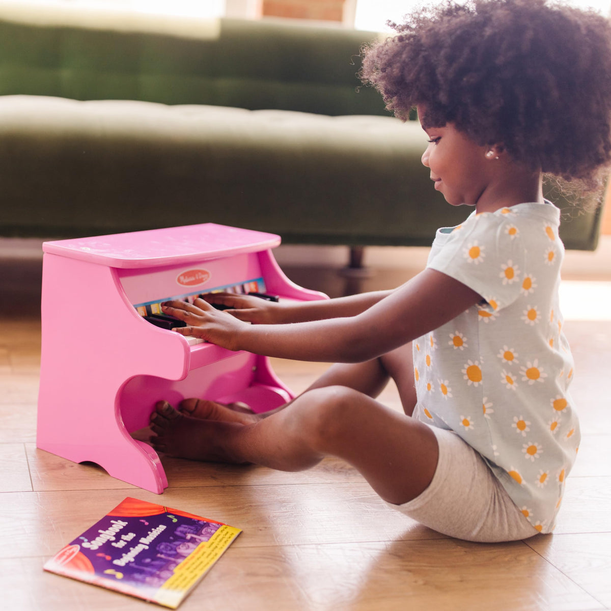 Melissa & Doug color-coded songbook helps kids follow notes easily.