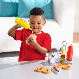 Melissa & Doug salt and pepper shakers in use, promoting fine motor play and counting