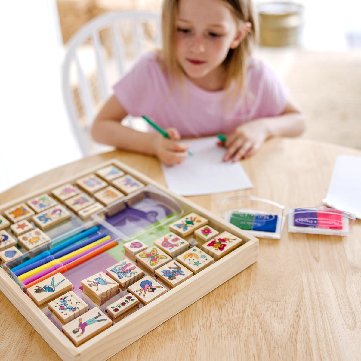 Melissa and Doug stamping activity decorates notebooks and cards with stamps.