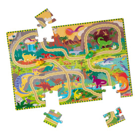 Melissa & Doug dinosaur adventure tracks puzzle laid out on floor for collaborative play