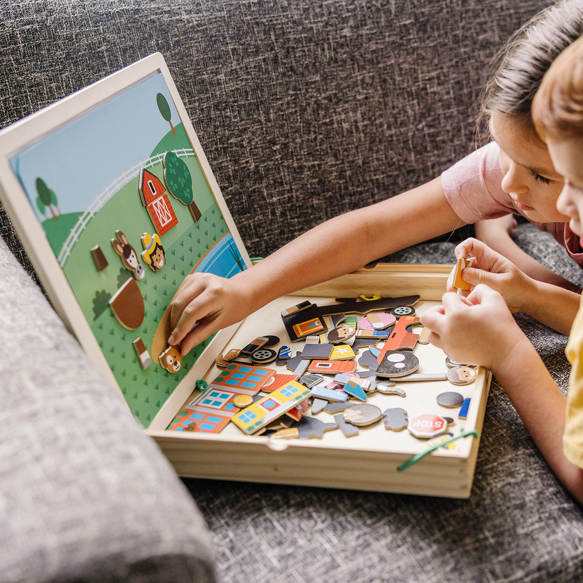 Melissa and Doug double-sided background card offers versatile play backdrops.
