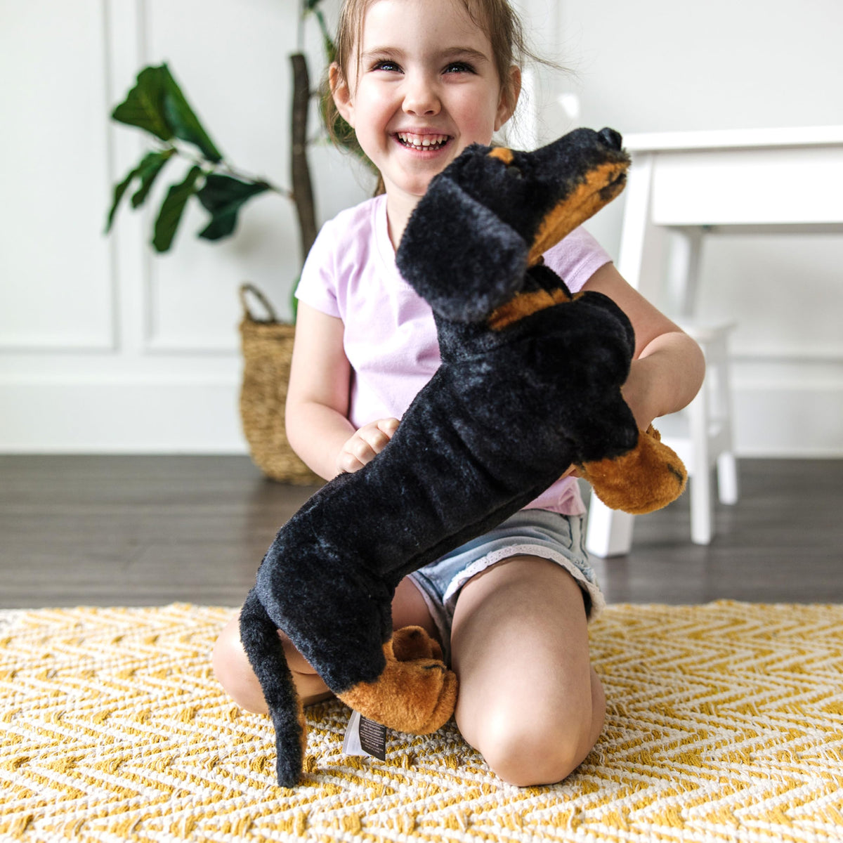 Melissa and Doug giant dachshund stuffed animal classic black and tan coloring.
