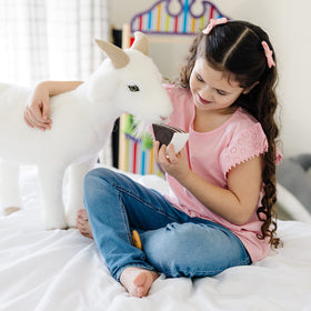 Soft-bodied Melissa & Doug goat plush for safe snuggles.