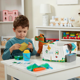 Melissa & Doug hay and grain bins enable realistic feeding play.