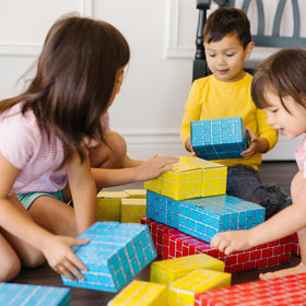 Kids building a tower with Melissa & Doug blocks fosters cooperation.