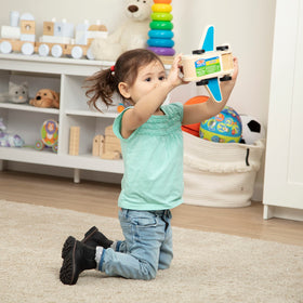 Kids enjoy open-ended play with a Melissa & Doug wooden airplane.