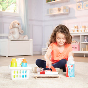 Melissa & Doug box of pretend dryer sheets adds playtime detail.