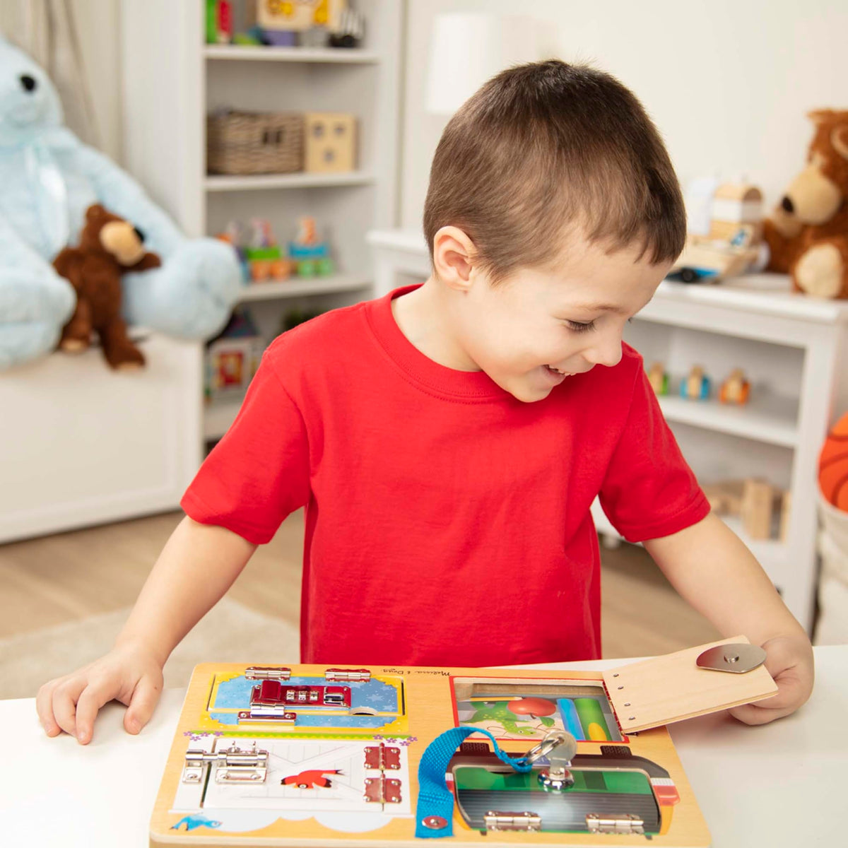 Child opens and closes different latches on Melissa and Doug Locks and Latches Board for motor skill growth.
