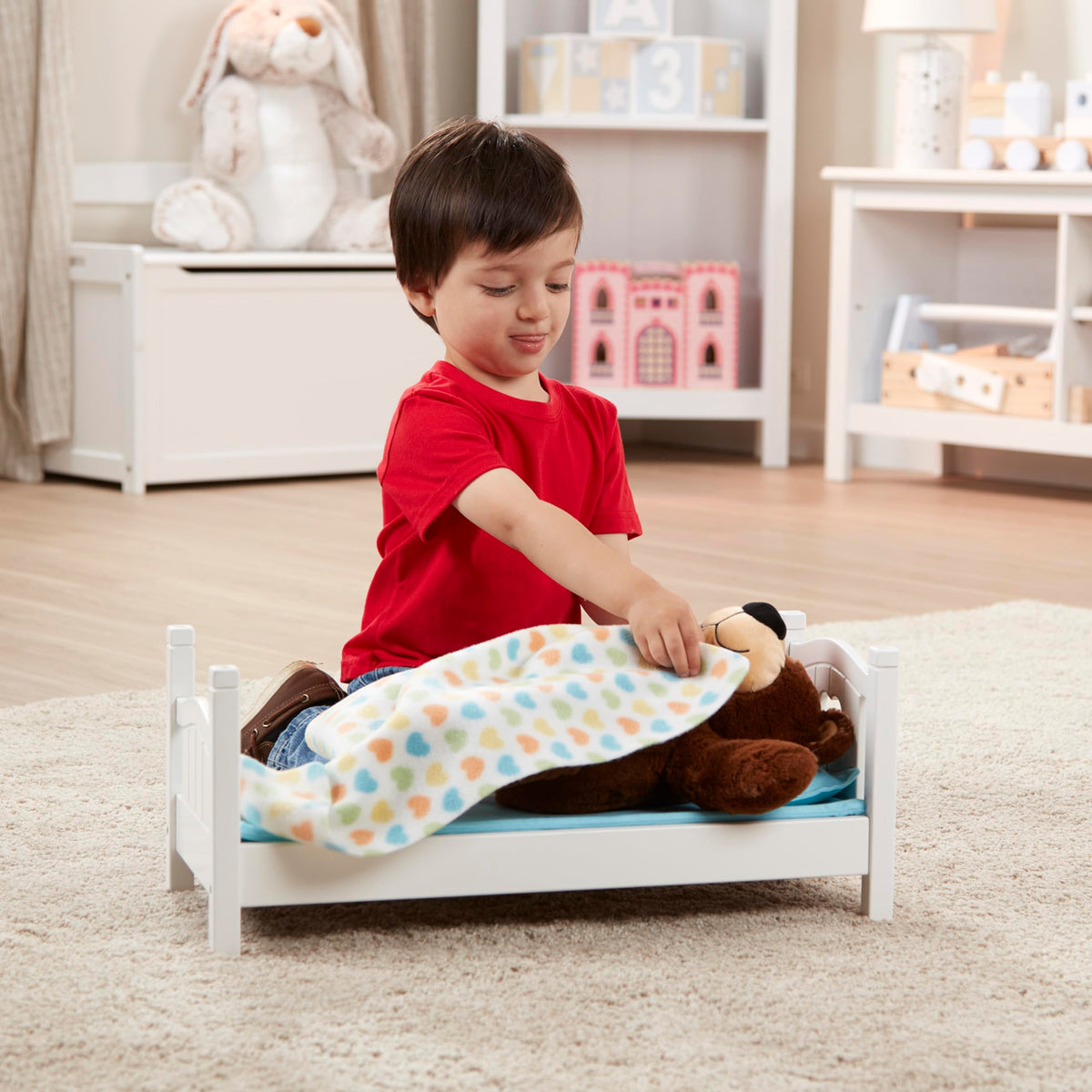 Child playing imaginatively with Melissa & Doug Mine to Love bed