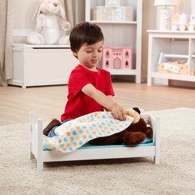 Child playing imaginatively with Melissa & Doug Mine to Love bed