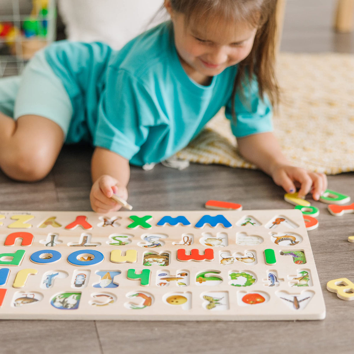 Melissa and Doug pieces with pictures underneath to aid letter matching