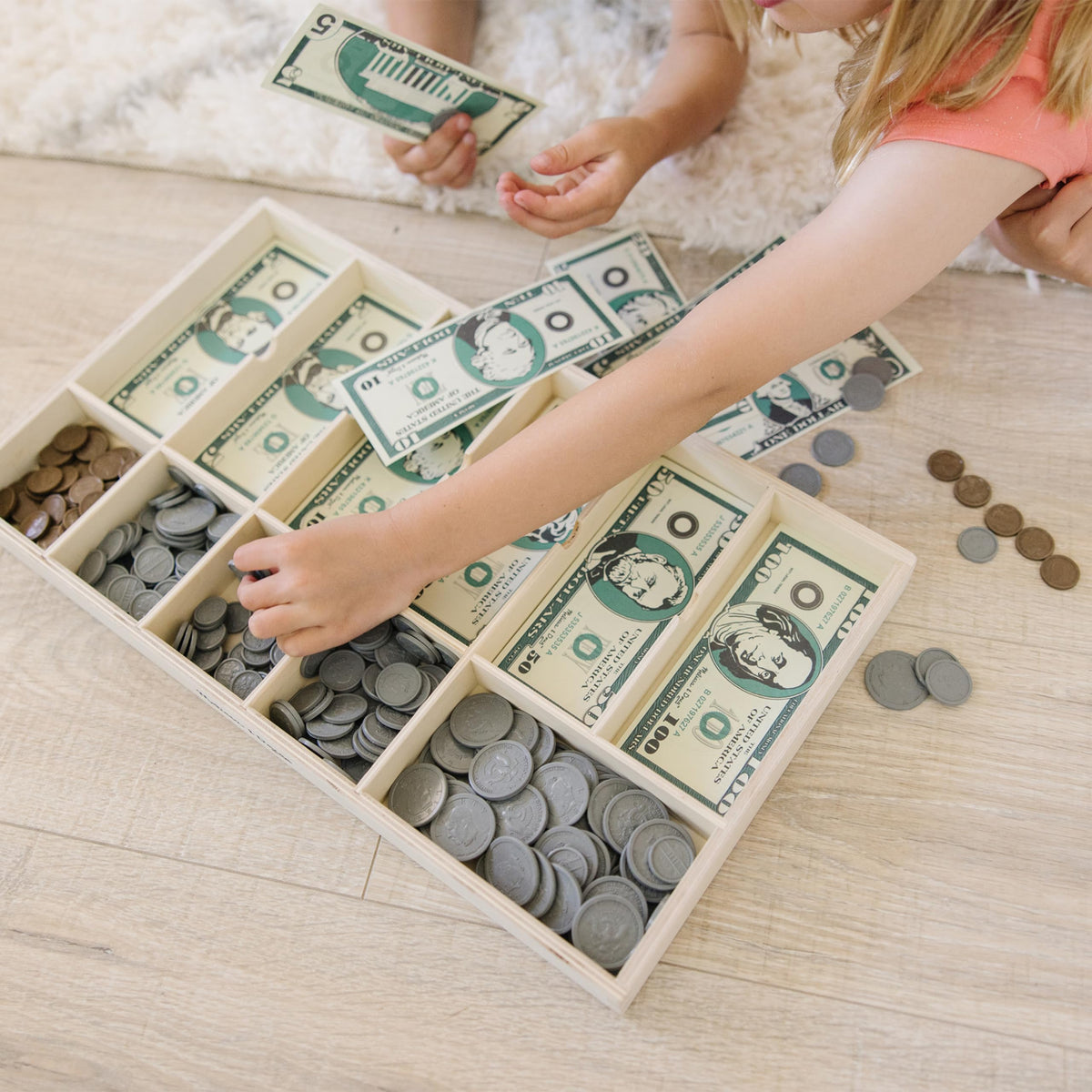 Melissa & Doug plastic coins from pennies to quarters support counting and currency recognition.