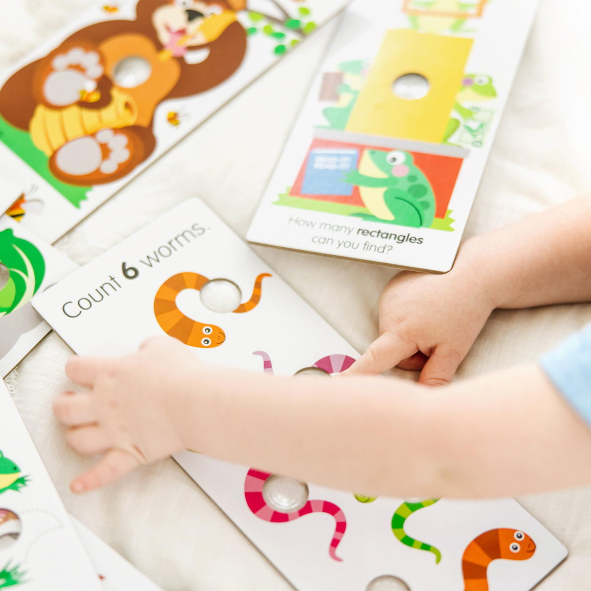 Melissa & Doug Poke-a-Dot Shapes card helps recognize basic shapes.