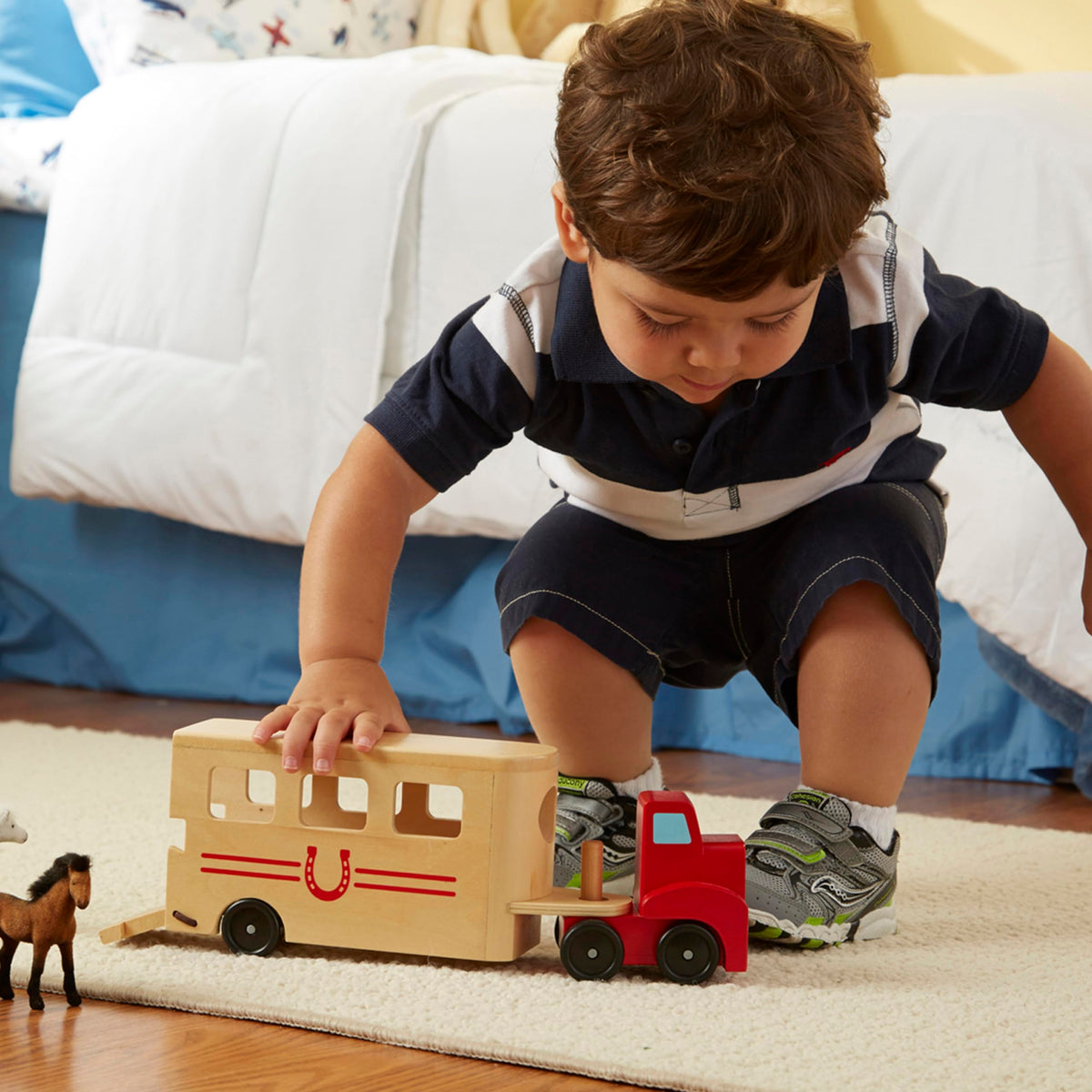 Melissa & Doug pull-down ramp supports easy loading and unloading of flocked horses.