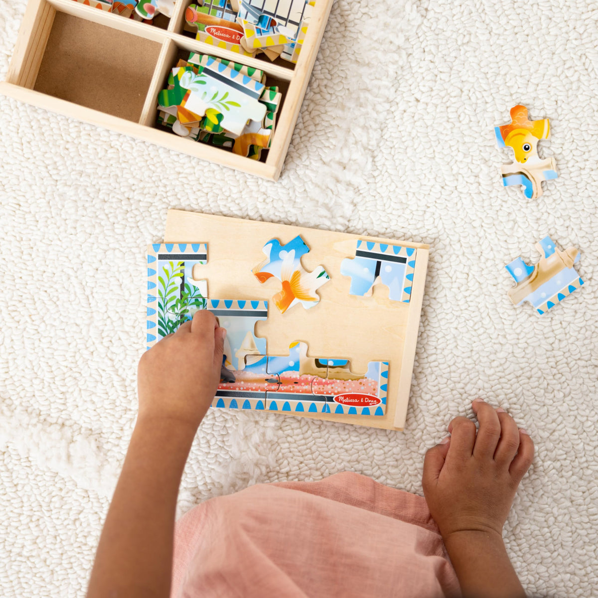 Melissa & Doug slide-on lid puzzle board shown on a wooden box for travel