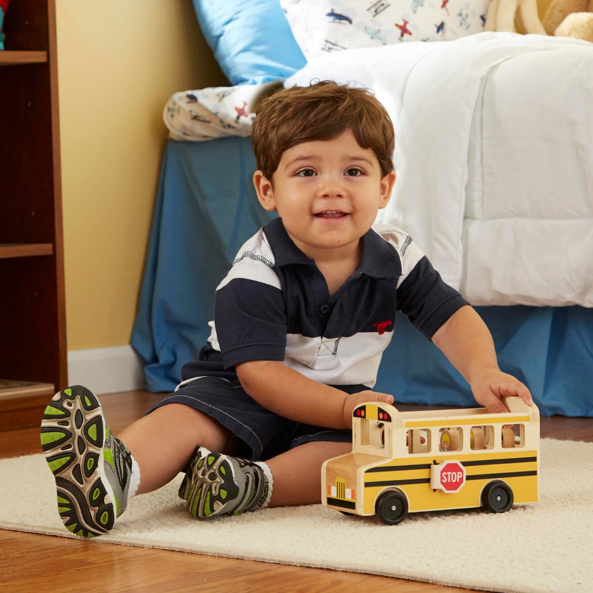 Driver figure sits at the wheel in Melissa and Doug school bus set for pretend commuting