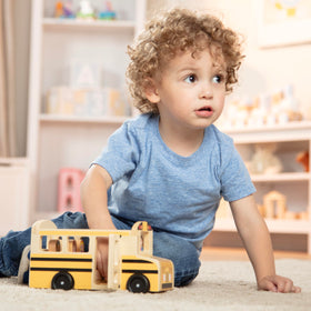 Passenger figure four ready for storytime on Melissa and Doug bus