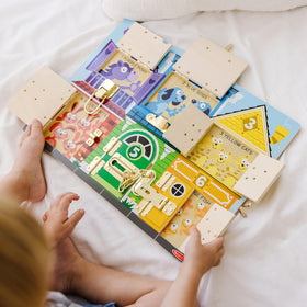 Melissa & Doug six-latch busy board to develop fine motor skills.