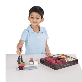 Melissa & Doug dipping bowl and chopsticks support hands-on play.